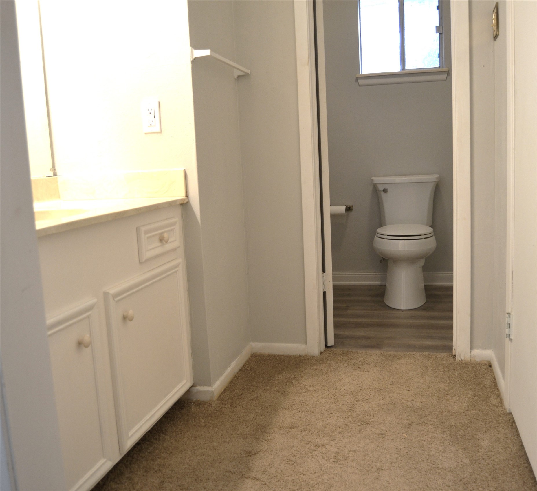 101 Summit Drive Conroe, TX 77303 - Photo 19 of 24 a view of a hallway with toilet and a window