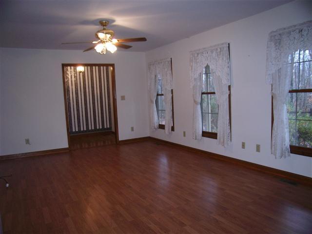 220 Leon Cole Road Dover, TN 37058 - Photo 5 of 20 Spacious living room, ceiling fan, laminate flooring. Entry foyer in the background.