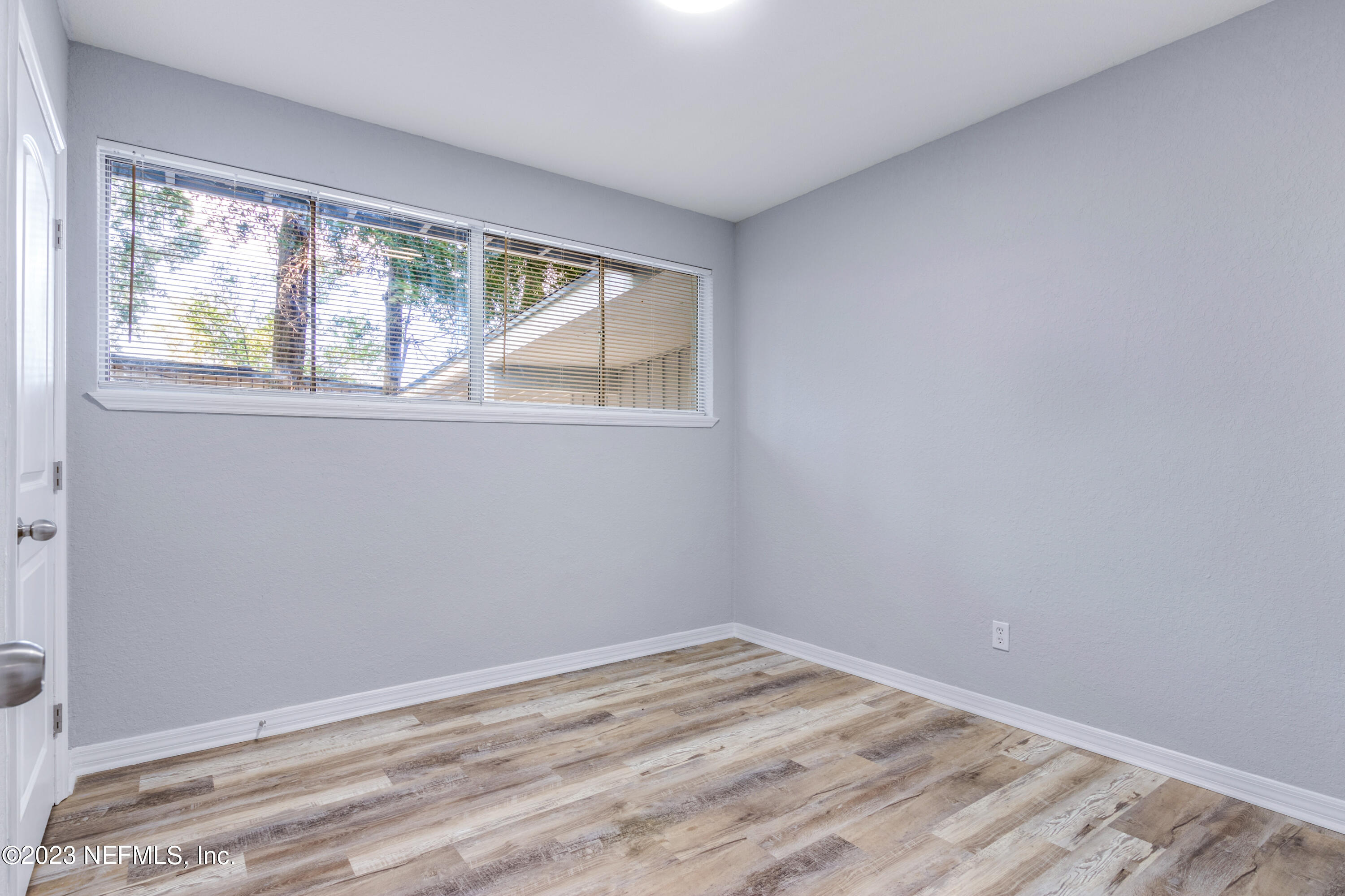 1226 Morgana Road Jacksonville, FL 32211 - Photo 22 of 38 a view of empty room with wooden floor and fan