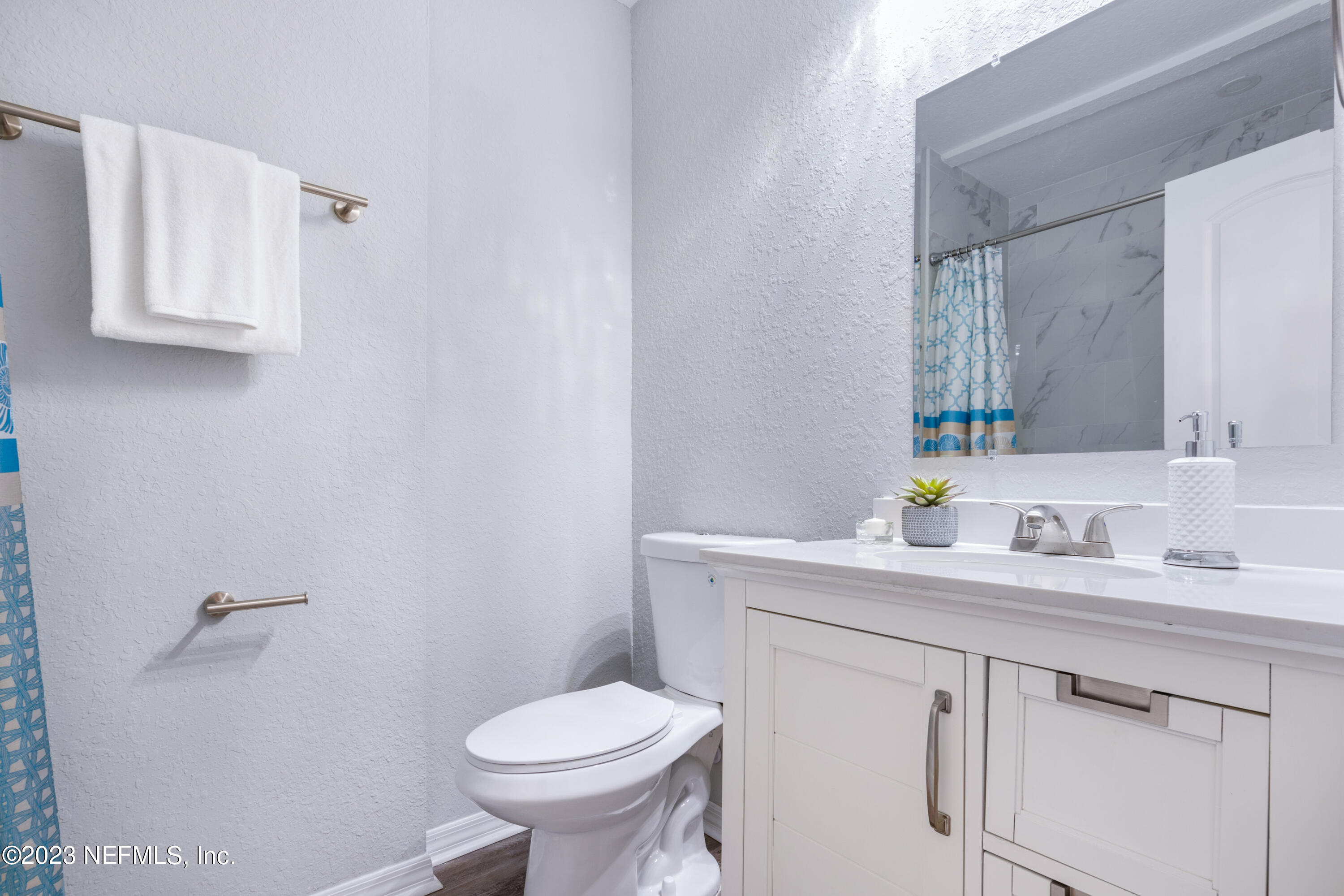 1226 Morgana Road Jacksonville, FL 32211 - Photo 23 of 38 a bathroom with a granite countertop sink mirror and toilet