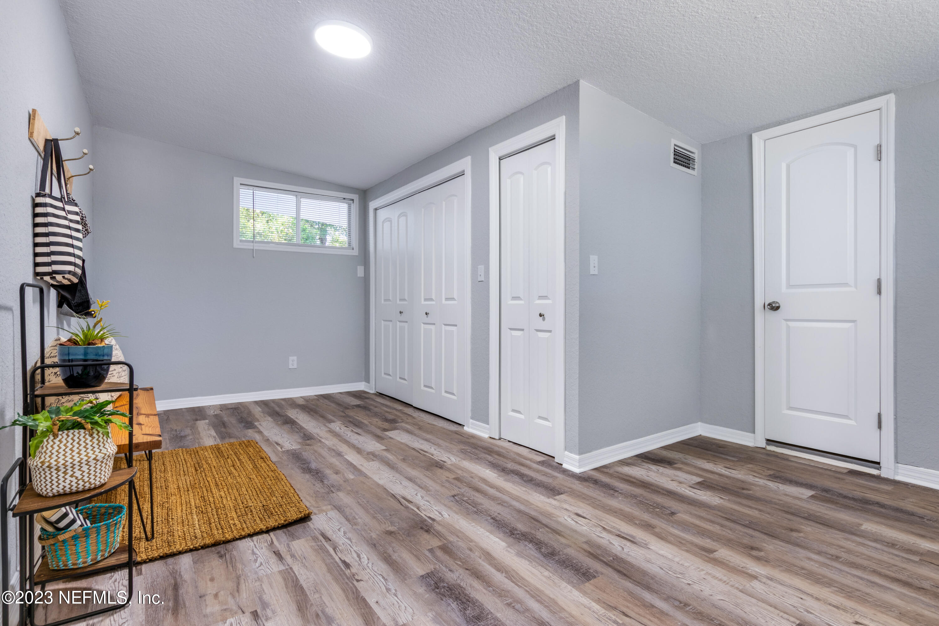 1226 Morgana Road Jacksonville, FL 32211 - Photo 26 of 38 a view of an empty room and kitchen with wooden floor