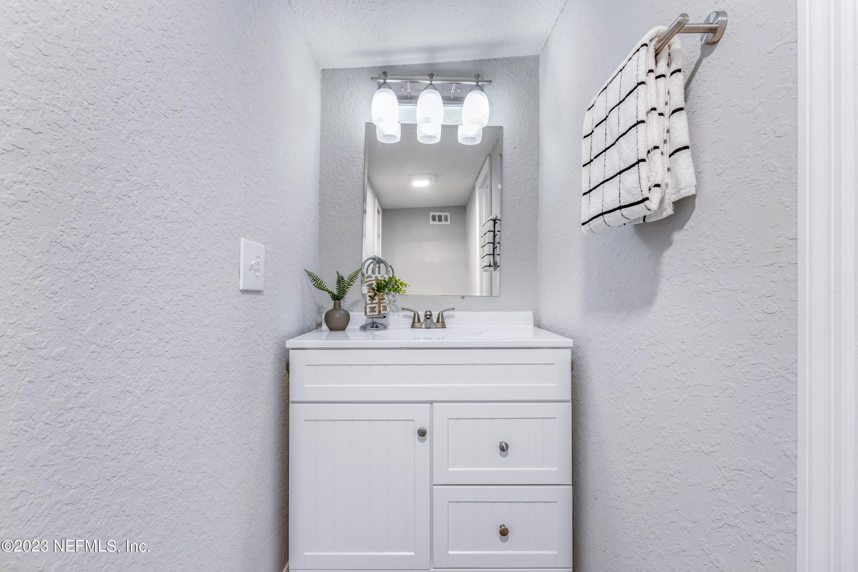 1226 Morgana Road Jacksonville, FL 32211 - Photo 29 of 38 a bathroom with a sink and mirror