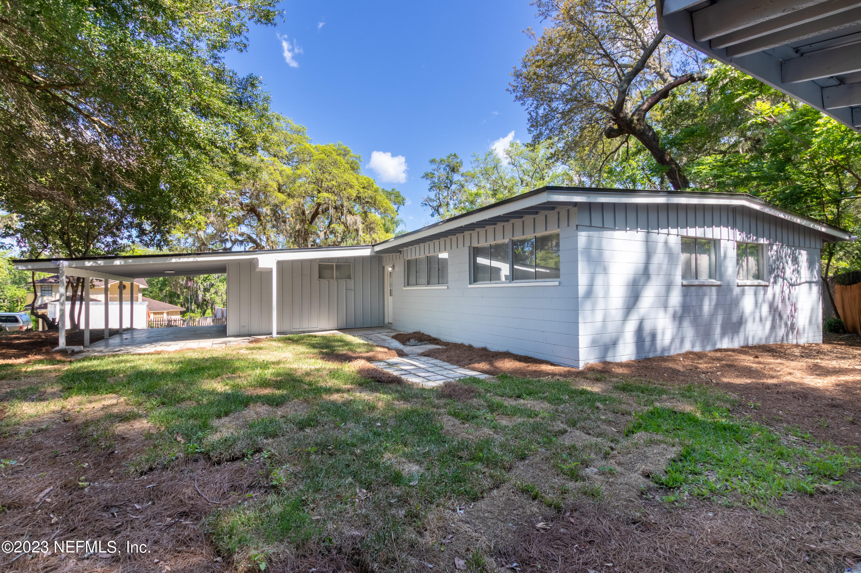 1226 Morgana Road Jacksonville, FL 32211 - Photo 35 of 38 a backyard of a house with wooden deck and seating space