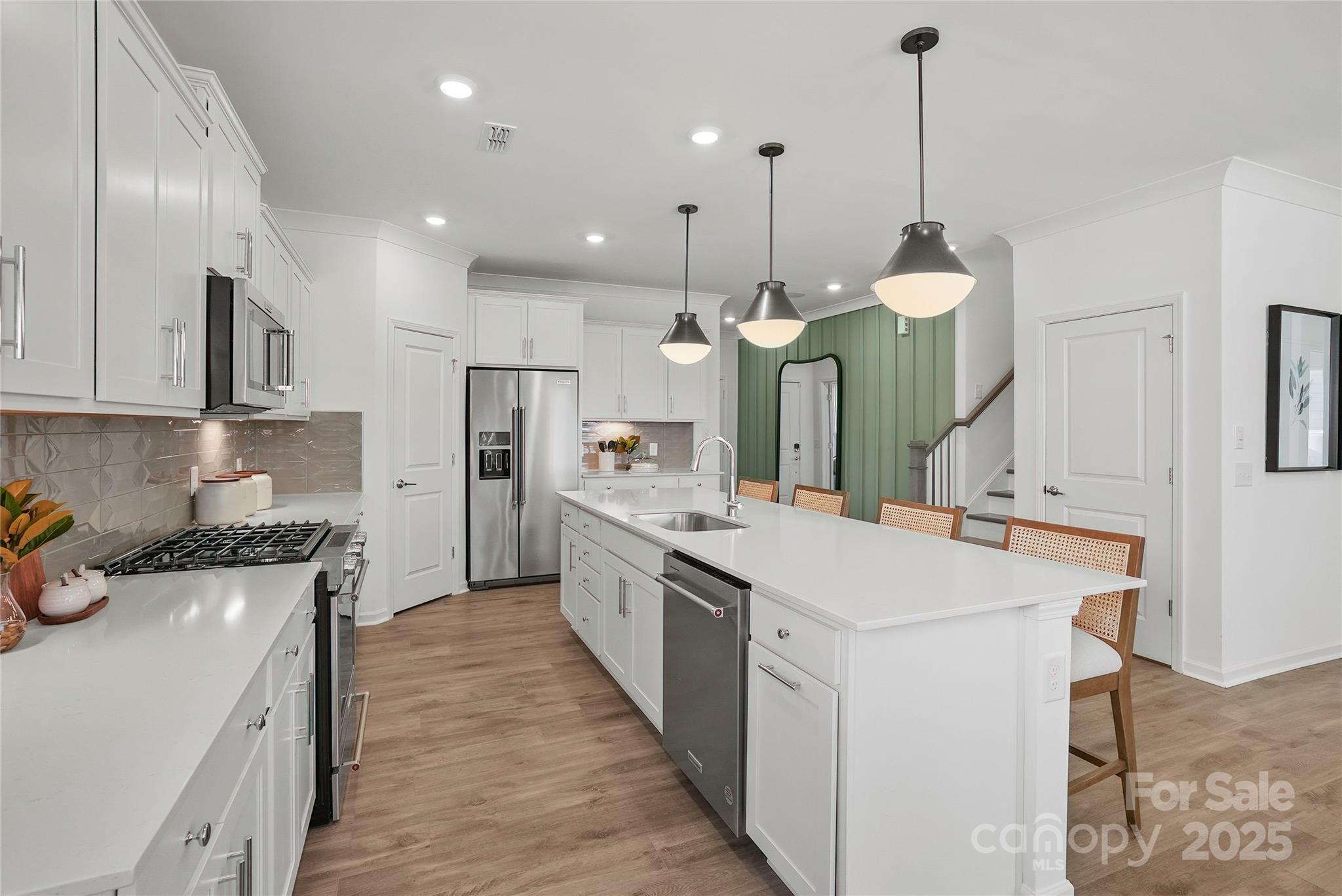 2213 Dickson Court, Unit 52 Monroe, NC 28110 - Photo 14 of 48 a kitchen with white cabinets appliances and a chandelier