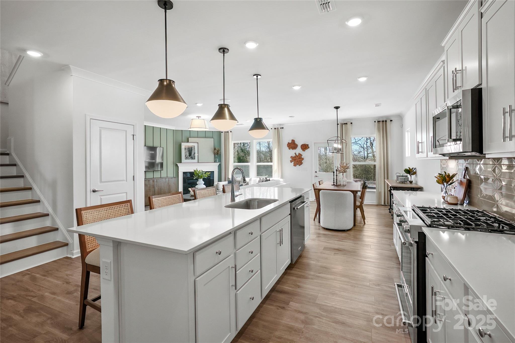 2213 Dickson Court, Unit 52 Monroe, NC 28110 - Photo 15 of 48 a open kitchen with stainless steel appliances granite countertop a stove and kitchen island