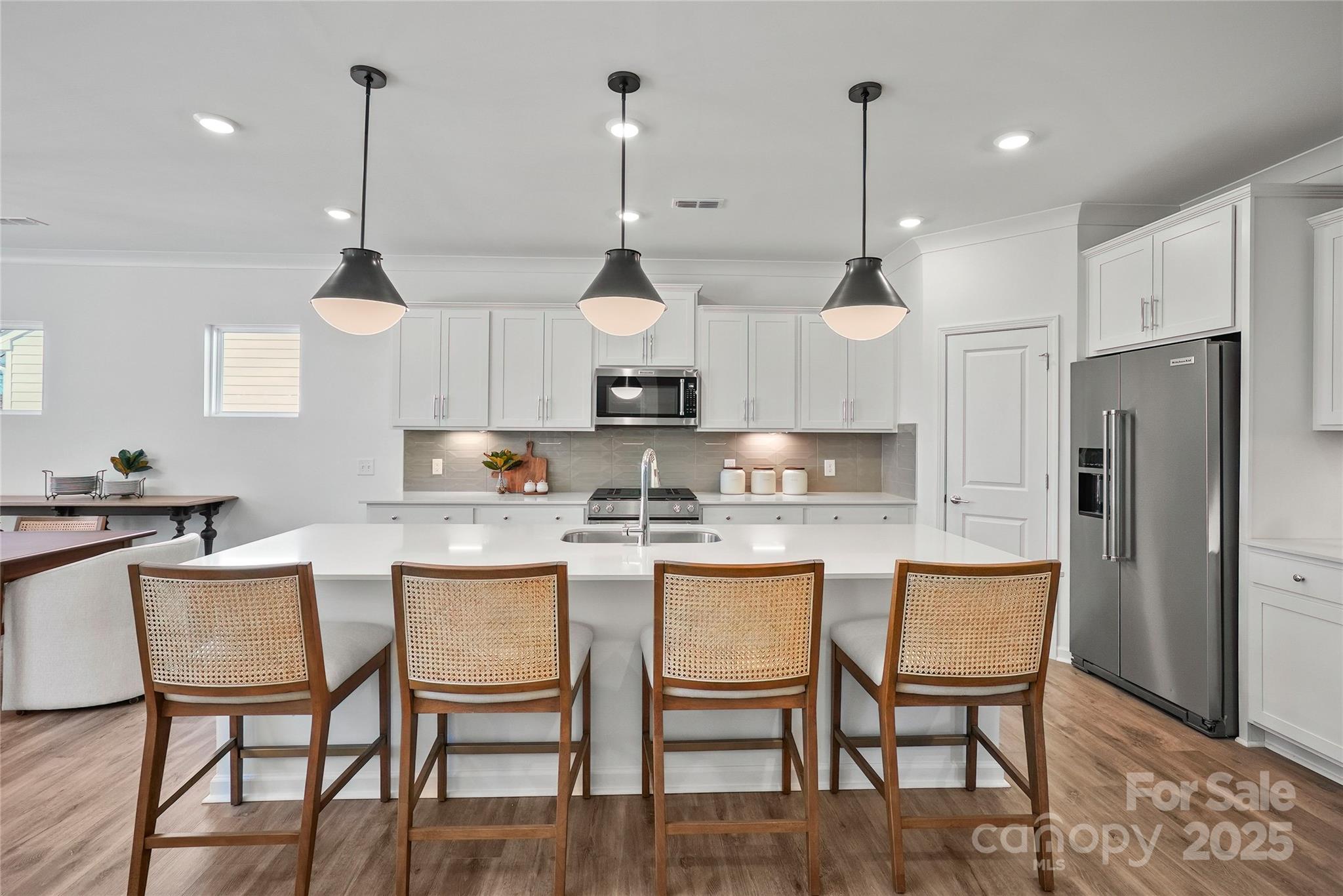 2213 Dickson Court, Unit 52 Monroe, NC 28110 - Photo 16 of 48 a kitchen with stainless steel appliances granite countertop a kitchen island a table and chairs