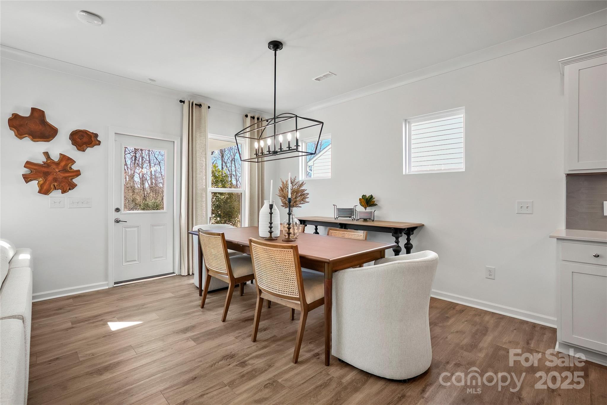 2213 Dickson Court, Unit 52 Monroe, NC 28110 - Photo 17 of 48 a view of a dining room with furniture a chandelier and wooden floor