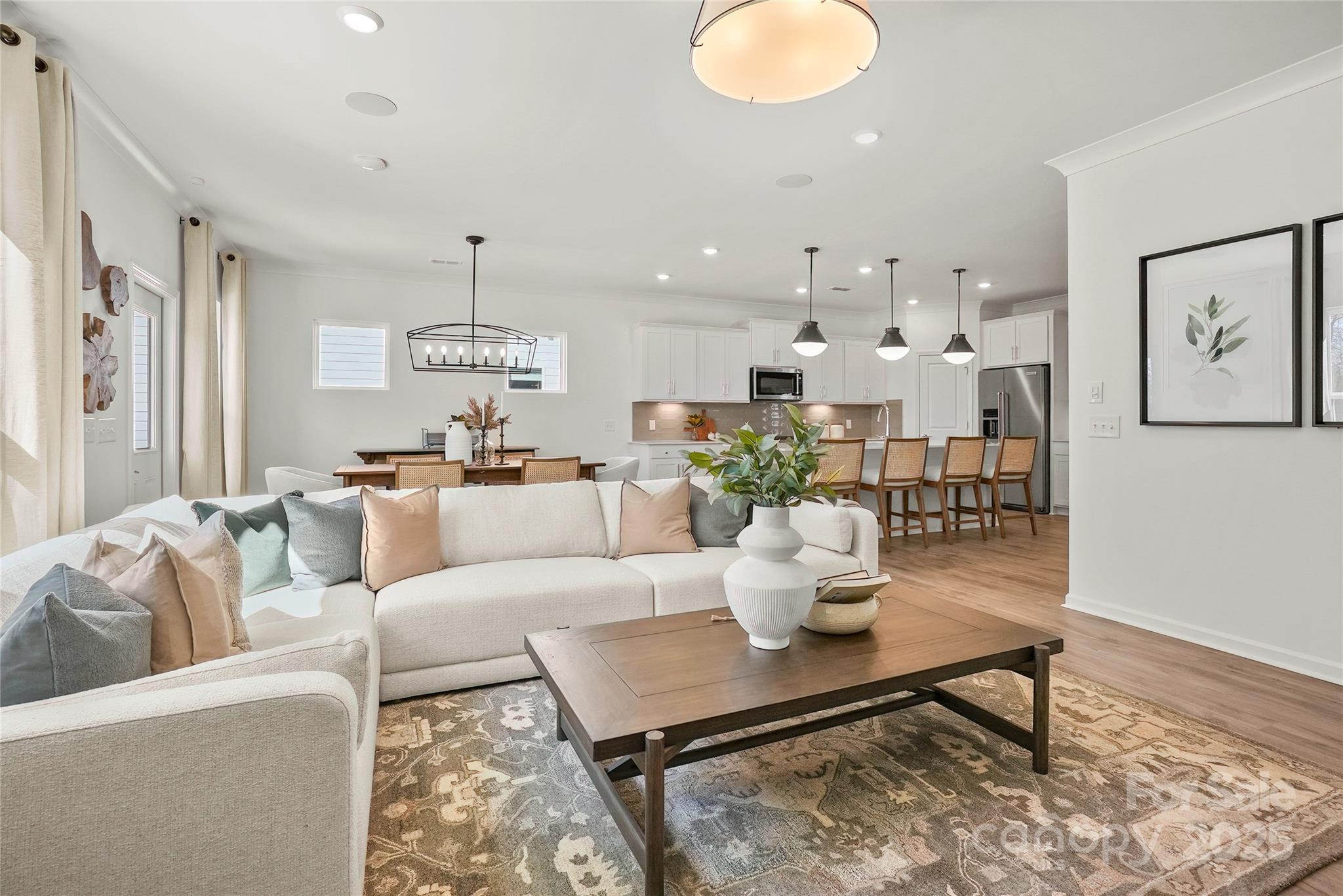 2213 Dickson Court, Unit 52 Monroe, NC 28110 - Photo 23 of 48 a living room with furniture kitchen view and a table