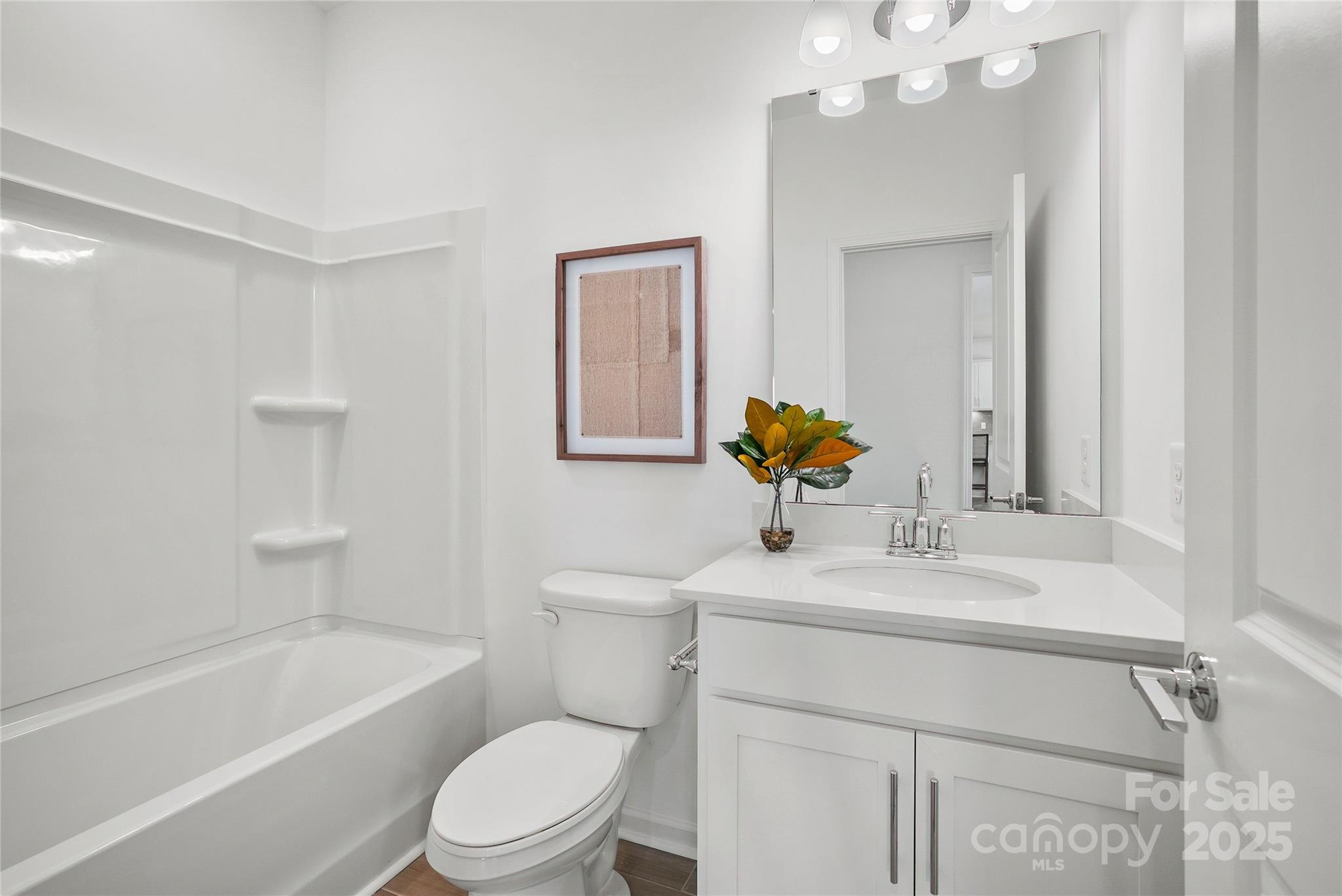 2213 Dickson Court, Unit 52 Monroe, NC 28110 - Photo 27 of 48 a bathroom with a sink vanity mirror toilet and bathtub