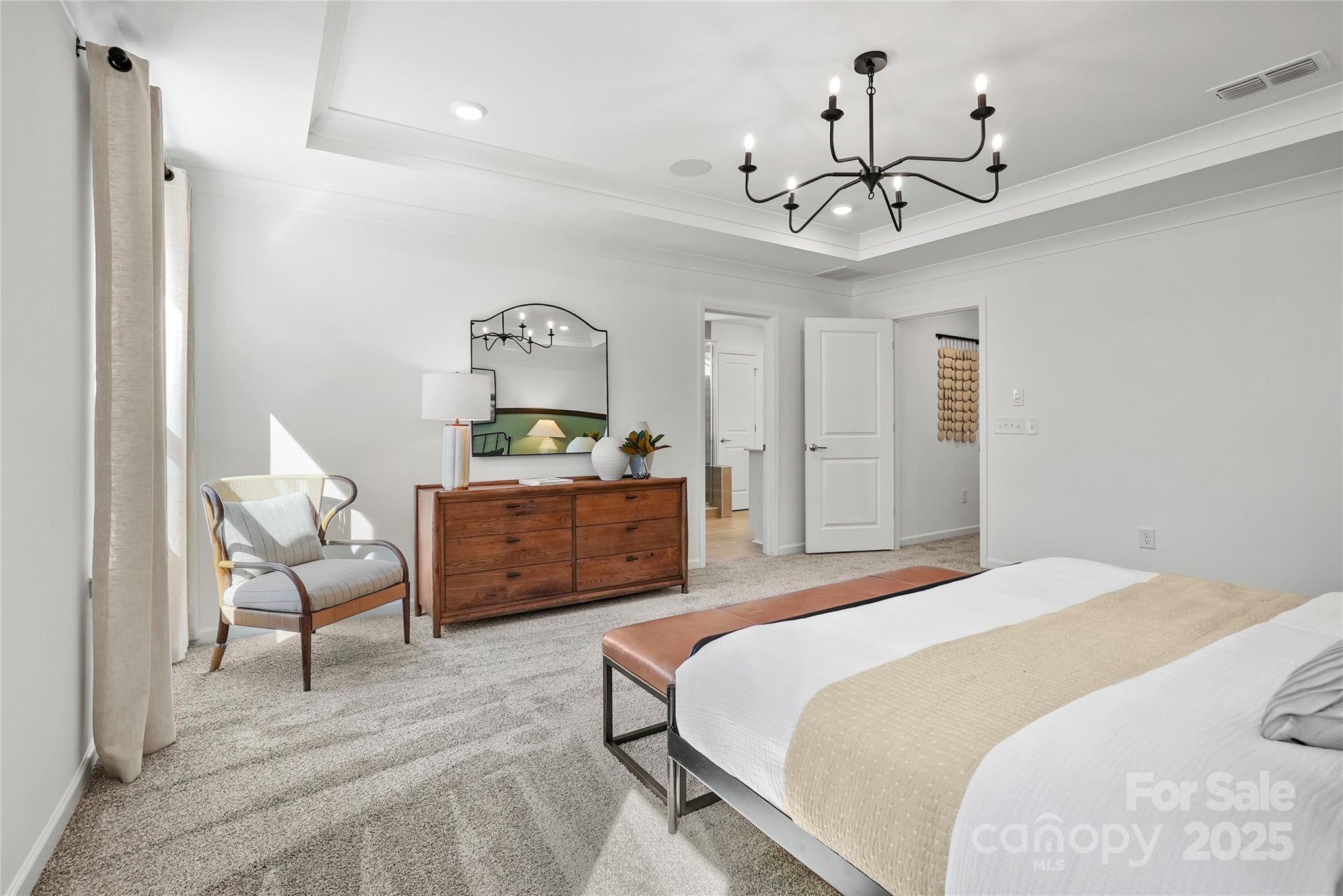 2213 Dickson Court, Unit 52 Monroe, NC 28110 - Photo 37 of 48 a bedroom with a bed couch chandelier and a window