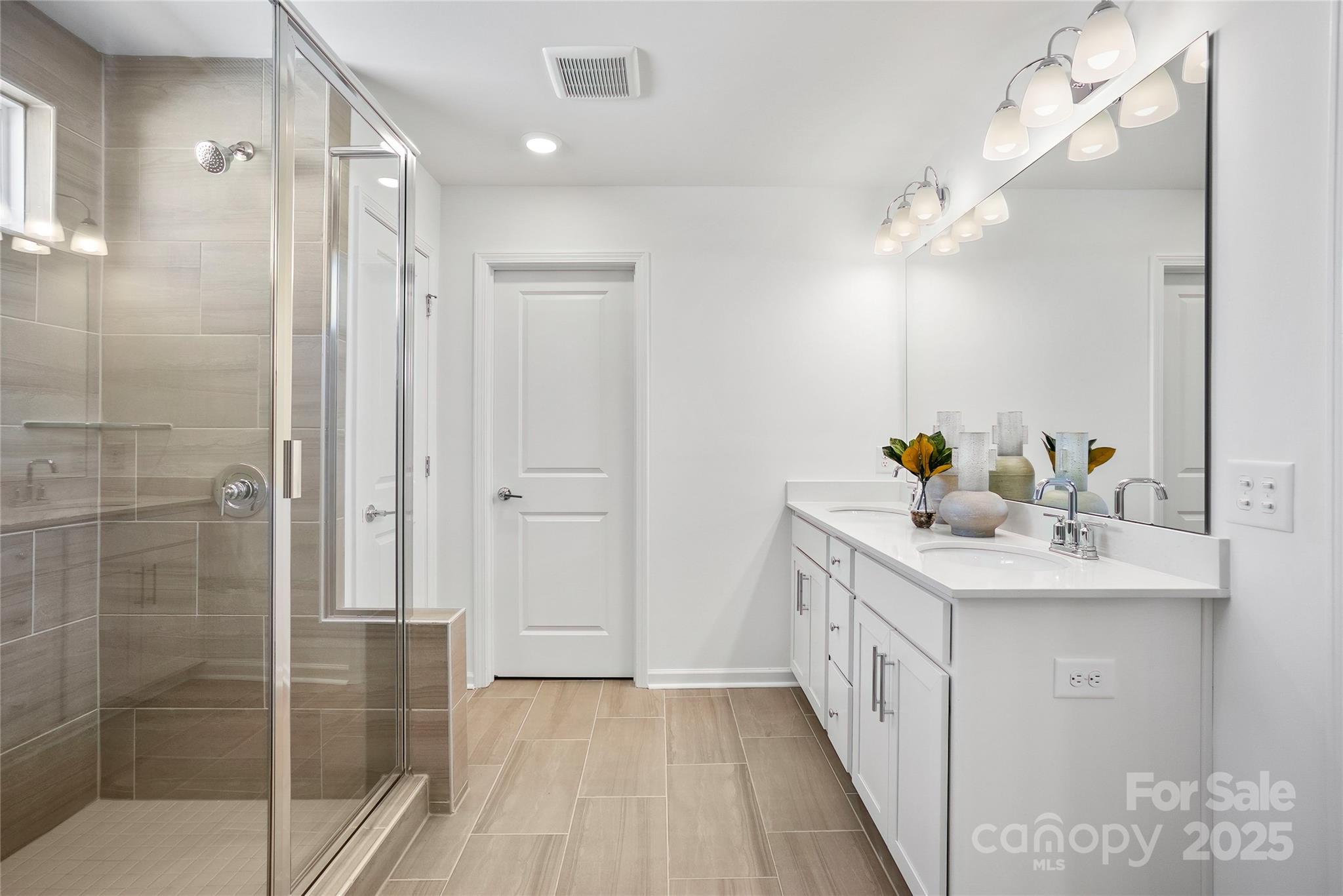 2213 Dickson Court, Unit 52 Monroe, NC 28110 - Photo 38 of 48 a bathroom with a sink a mirror and shower