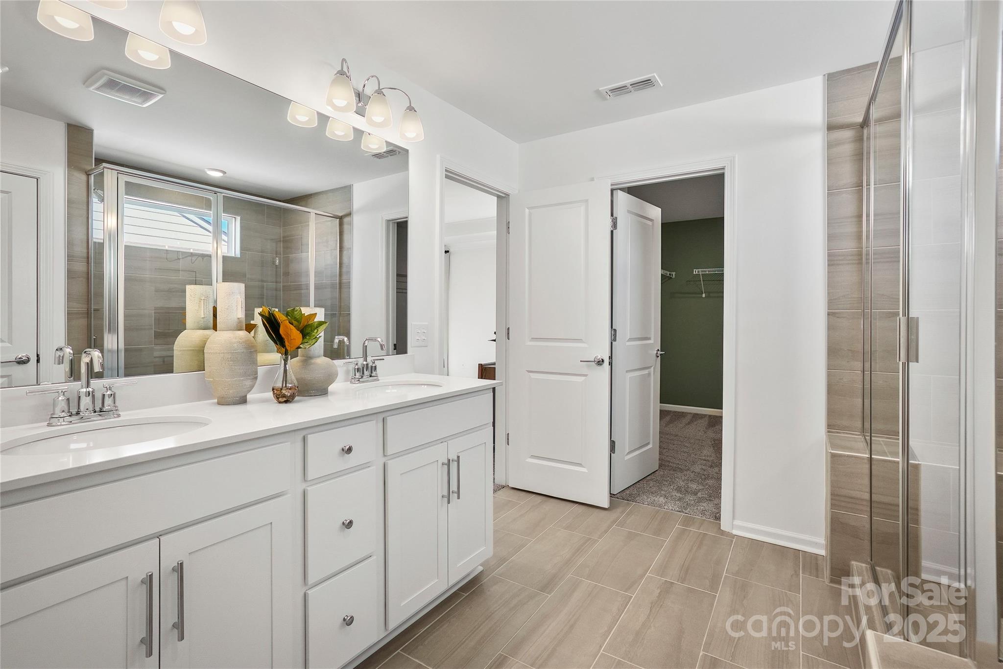 2213 Dickson Court, Unit 52 Monroe, NC 28110 - Photo 39 of 48 a spacious bathroom with a double vanity sink a mirror and shower
