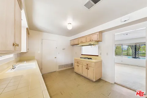a kitchen with a stove and a sink