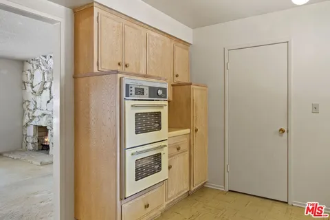 a kitchen with stainless steel appliances a refrigerator and cabinets