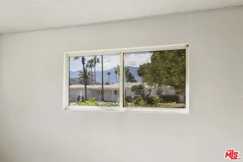 a bathroom with a granite countertop sink toilet and mirror