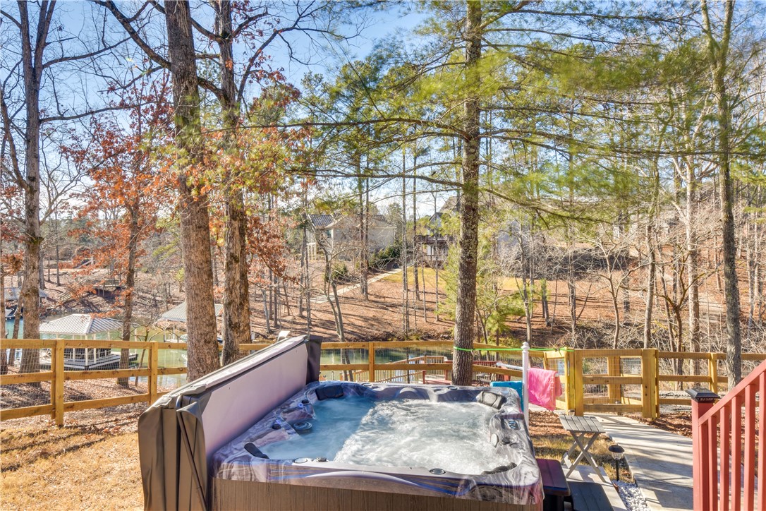 206 Petty Road Seneca, SC 29672 - Photo 36 of 48 A tranquil hot tub awaits on the patio, offering serene views of the lake and surrounding woodlands.