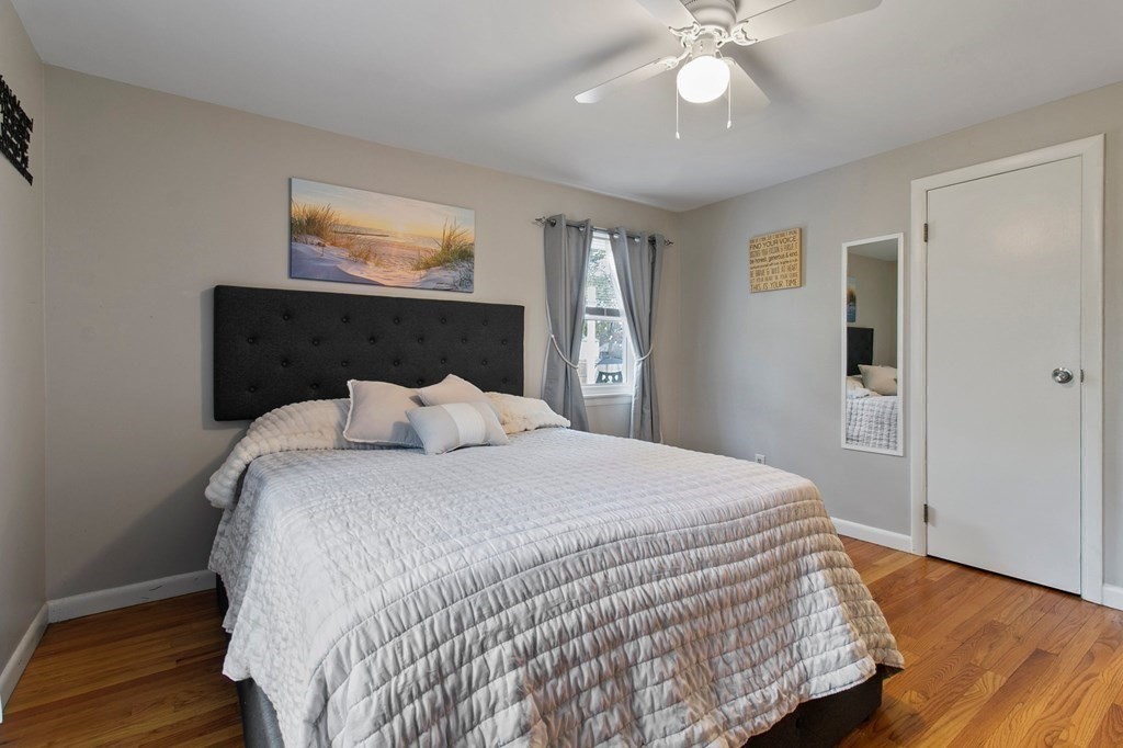 52 Portulaca Drive Springfield, MA 01129 - Photo 13 of 36 a bedroom with a large bed and a chandelier
