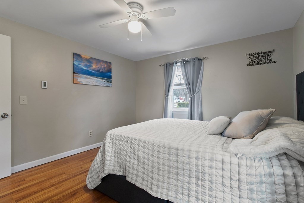 52 Portulaca Drive Springfield, MA 01129 - Photo 14 of 36 a bedroom with a bed and wooden floor
