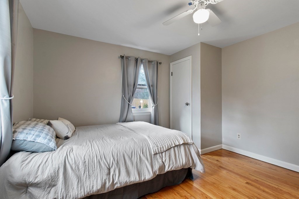 52 Portulaca Drive Springfield, MA 01129 - Photo 18 of 36 a bedroom with a bed and a chandelier