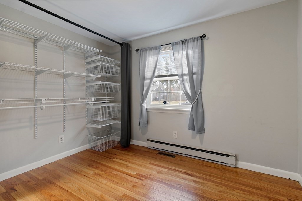 52 Portulaca Drive Springfield, MA 01129 - Photo 20 of 36 a view of empty room with wooden floor and fan