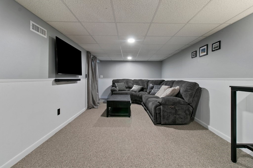 52 Portulaca Drive Springfield, MA 01129 - Photo 25 of 36 a living room with furniture and a flat screen tv