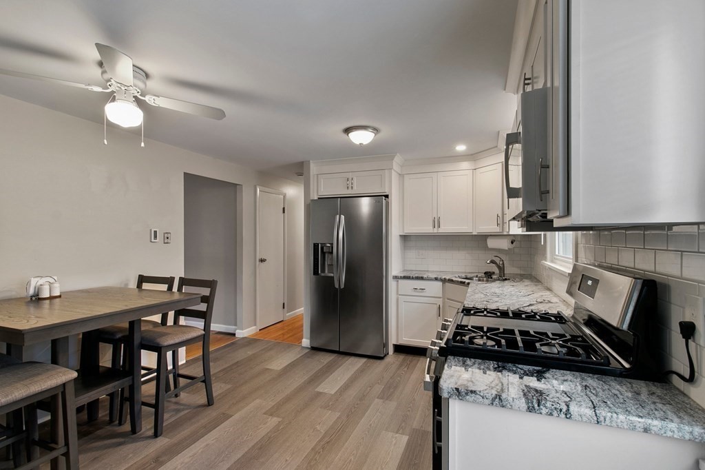 52 Portulaca Drive Springfield, MA 01129 - Photo 6 of 36 a kitchen with a table and chairs in it