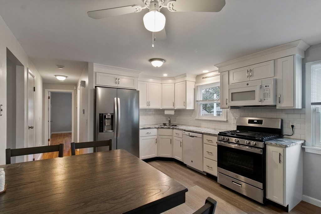 52 Portulaca Drive Springfield, MA 01129 - Photo 7 of 36 a kitchen with stainless steel appliances a stove a refrigerator sink and cabinets