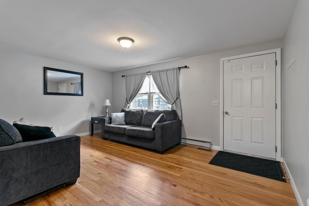 52 Portulaca Drive Springfield, MA 01129 - Photo 9 of 36 a living room with furniture and a wooden floor