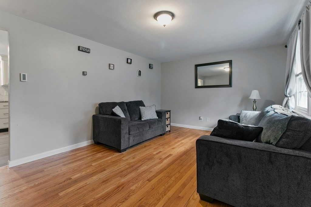 52 Portulaca Drive Springfield, MA 01129 - Photo 10 of 36 a living room with furniture and a wooden floor
