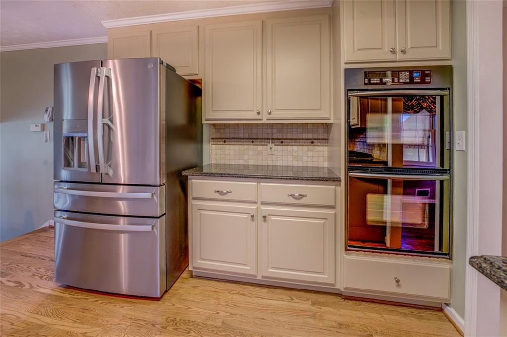740 Smyrna Road Southwest Conyers, GA 30094 - Photo 11 of 50 a kitchen with stainless steel appliances granite countertop a refrigerator and a stove top oven