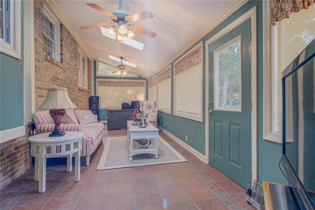 740 Smyrna Road Southwest Conyers, GA 30094 - Photo 21 of 50 a living room with furniture a chandelier and a large window