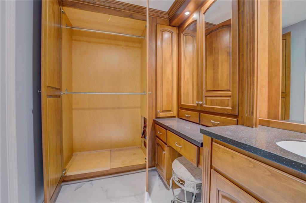 740 Smyrna Road Southwest Conyers, GA 30094 - Photo 29 of 50 a bathroom with a granite countertop sink and a mirror