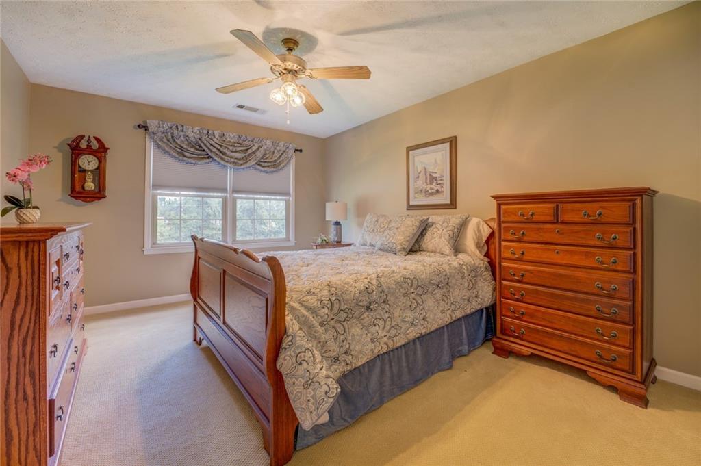 740 Smyrna Road Southwest Conyers, GA 30094 - Photo 32 of 50 a bedroom with a bed and a chandelier