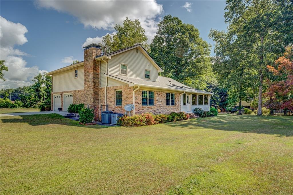 740 Smyrna Road Southwest Conyers, GA 30094 - Photo 37 of 50 a view of a house with swimming pool and garden