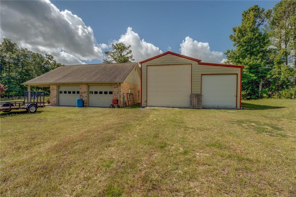 740 Smyrna Road Southwest Conyers, GA 30094 - Photo 41 of 50 a front view of a house with a yard and garage