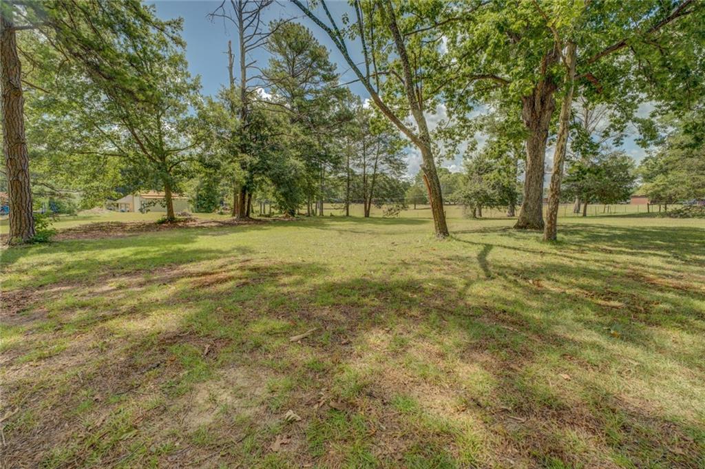 740 Smyrna Road Southwest Conyers, GA 30094 - Photo 47 of 50 a view of a field with trees