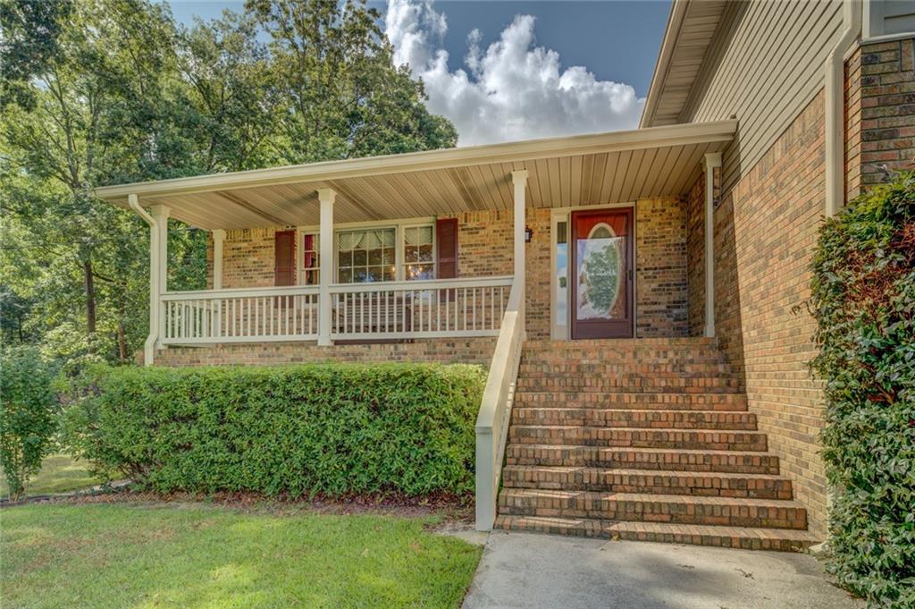 740 Smyrna Road Southwest Conyers, GA 30094 - Photo 5 of 50 a front view of a house with a garden