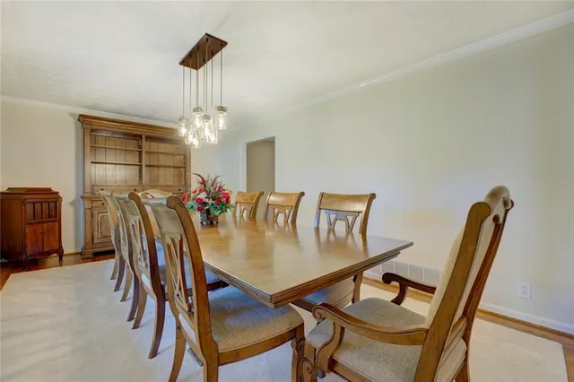 a kitchen with granite countertop white cabinets and stainless steel appliances