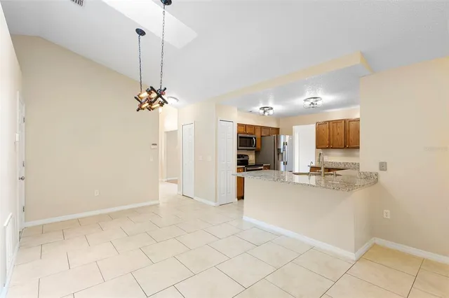 a view of an empty room with a ceiling fan