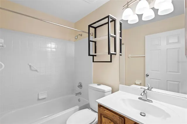 a view of a room with wooden floor and a ceiling fan