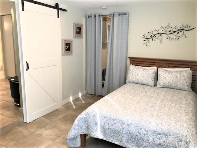 244 Hilltop Drive Santa Rosa Beach, FL 32459 - Photo 13 of 20 a bedroom with a bed and a refrigerator