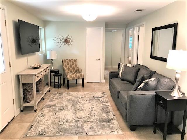 244 Hilltop Drive Santa Rosa Beach, FL 32459 - Photo 4 of 20 a living room with furniture flat screen tv and a fireplace