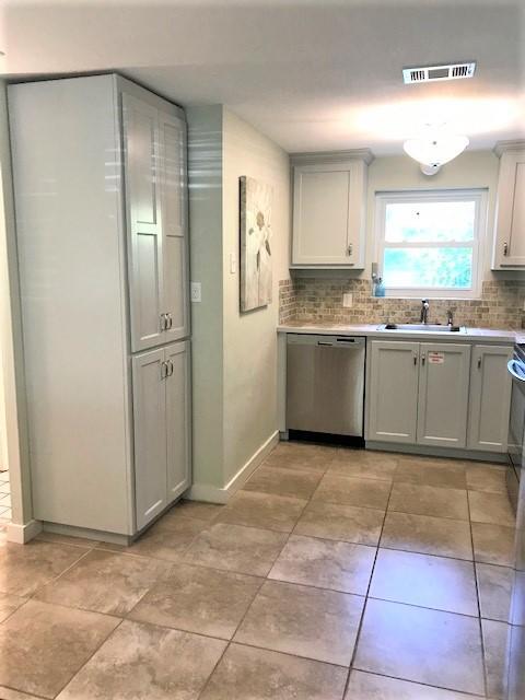 244 Hilltop Drive Santa Rosa Beach, FL 32459 - Photo 9 of 20 a kitchen with stainless steel appliances granite countertop a refrigerator and a sink