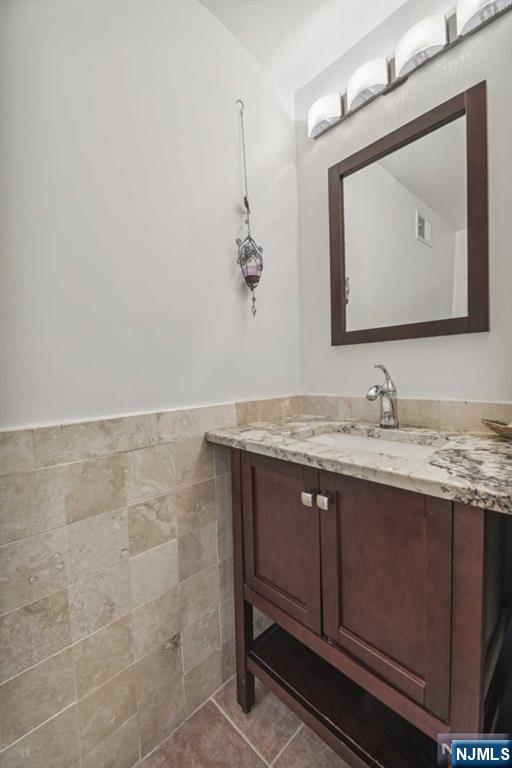 19 Center Street Cresskill, NJ 07626 - Photo 17 of 21 a bathroom with a granite countertop sink a mirror and vanity