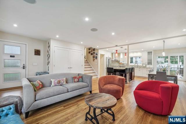 19 Center Street Cresskill, NJ 07626 - Photo 2 of 21 a living room with furniture a rug and kitchen view