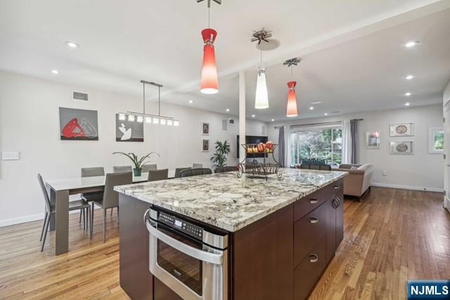 19 Center Street Cresskill, NJ 07626 - Photo 5 of 21 a kitchen with stainless steel appliances granite countertop a stove and a wooden floors