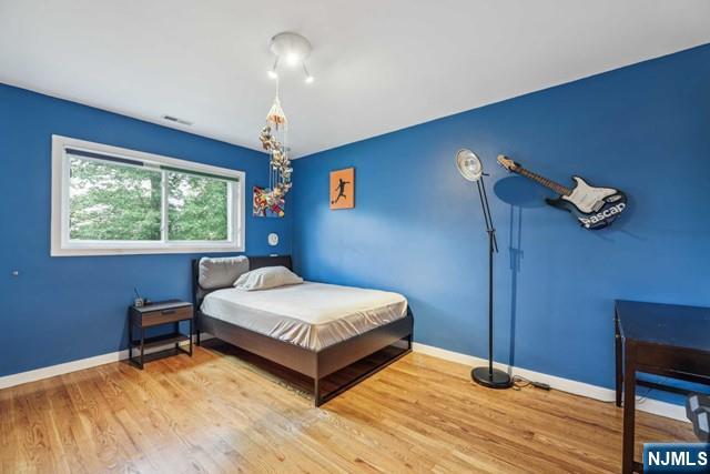 19 Center Street Cresskill, NJ 07626 - Photo 7 of 21 a bedroom with a bed and a window