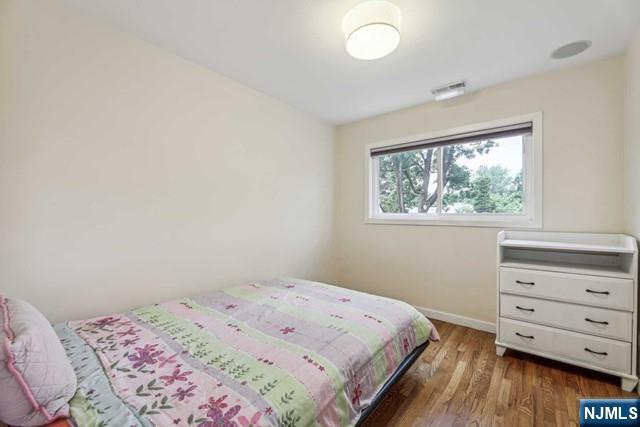 19 Center Street Cresskill, NJ 07626 - Photo 8 of 21 a bedroom with a bed and a window