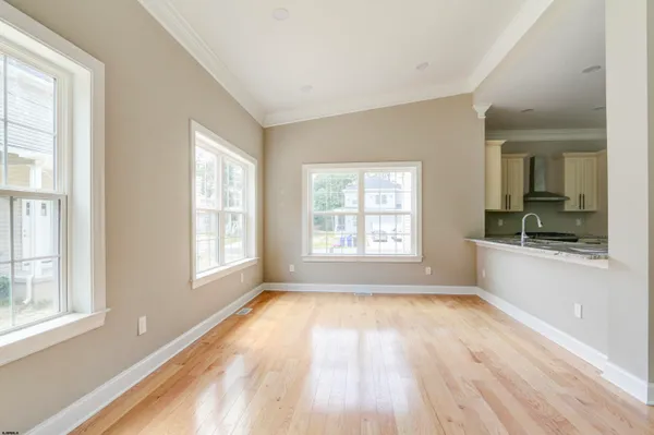 a view of kitchen with kitchen island and stainless steel appliances