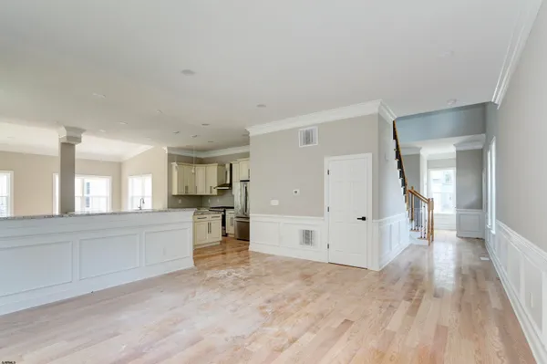 a view of a room with wooden floor and a window